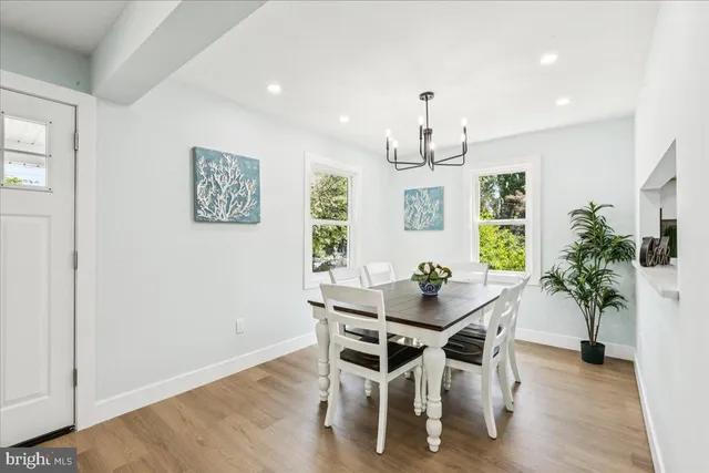 a view of a dining room with furniture window and wooden floor