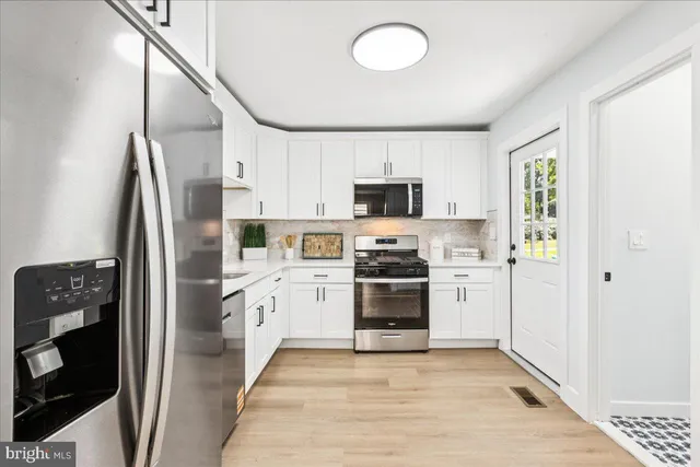 a kitchen with stainless steel appliances a refrigerator stove and sink