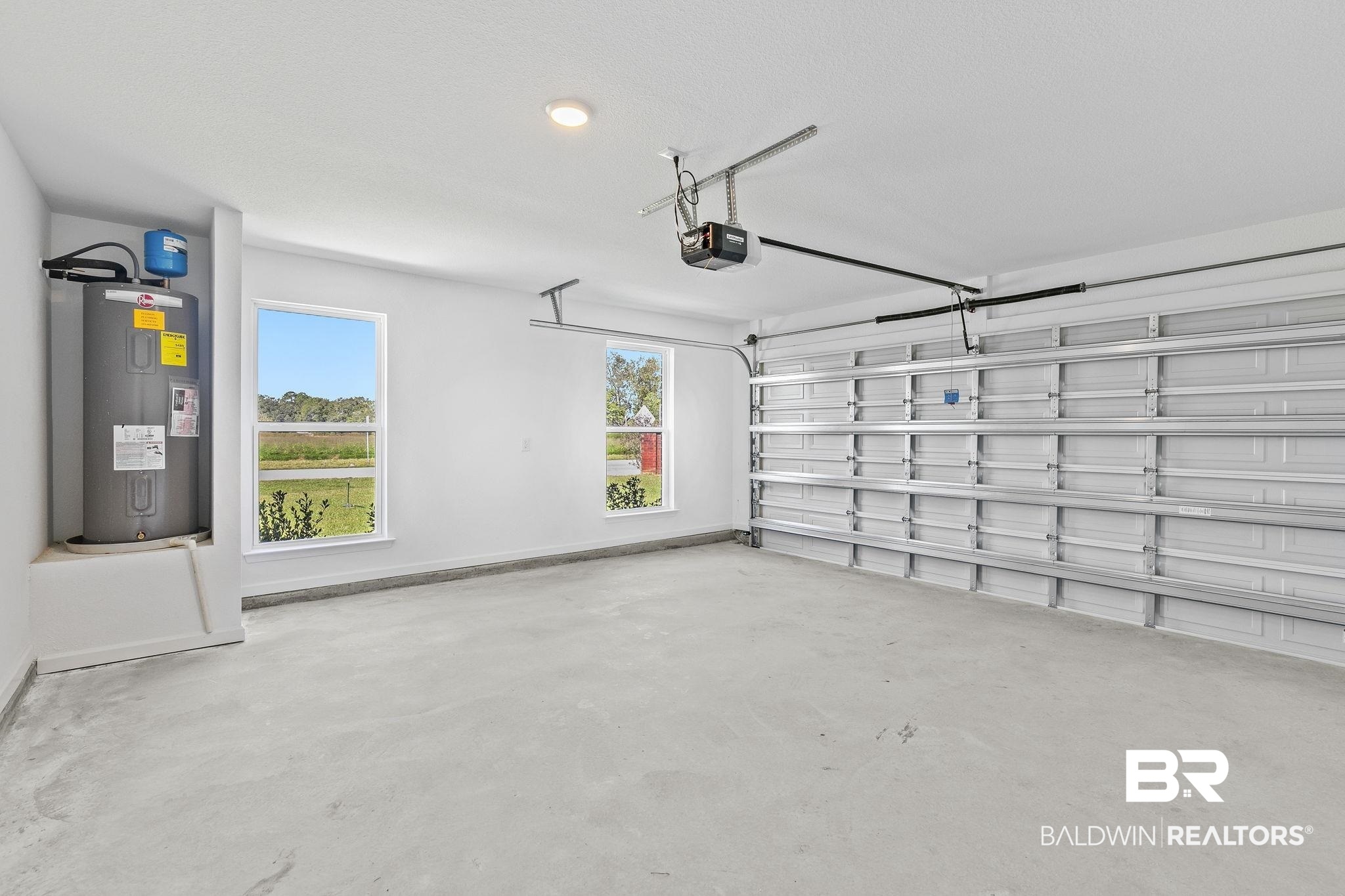16014 Alabama Avenue Silverhill, AL 36576 - Photo 35 of 50 Garage featuring a garage door opener and electric water heater