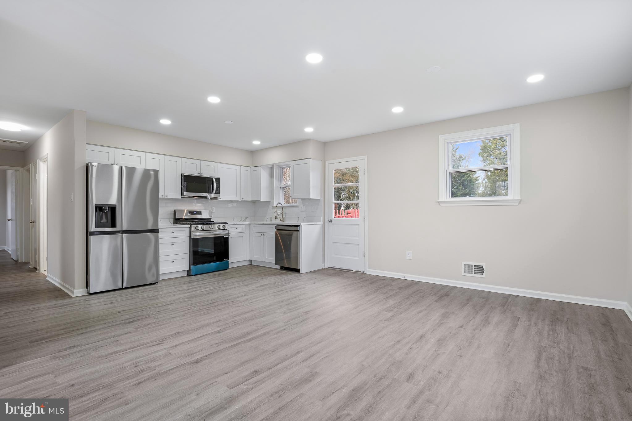 7804 D'Arcy Road District Heights, MD 20747 - Photo 11 of 61 a view of kitchen with stainless steel appliances wooden floor and white cabinets
