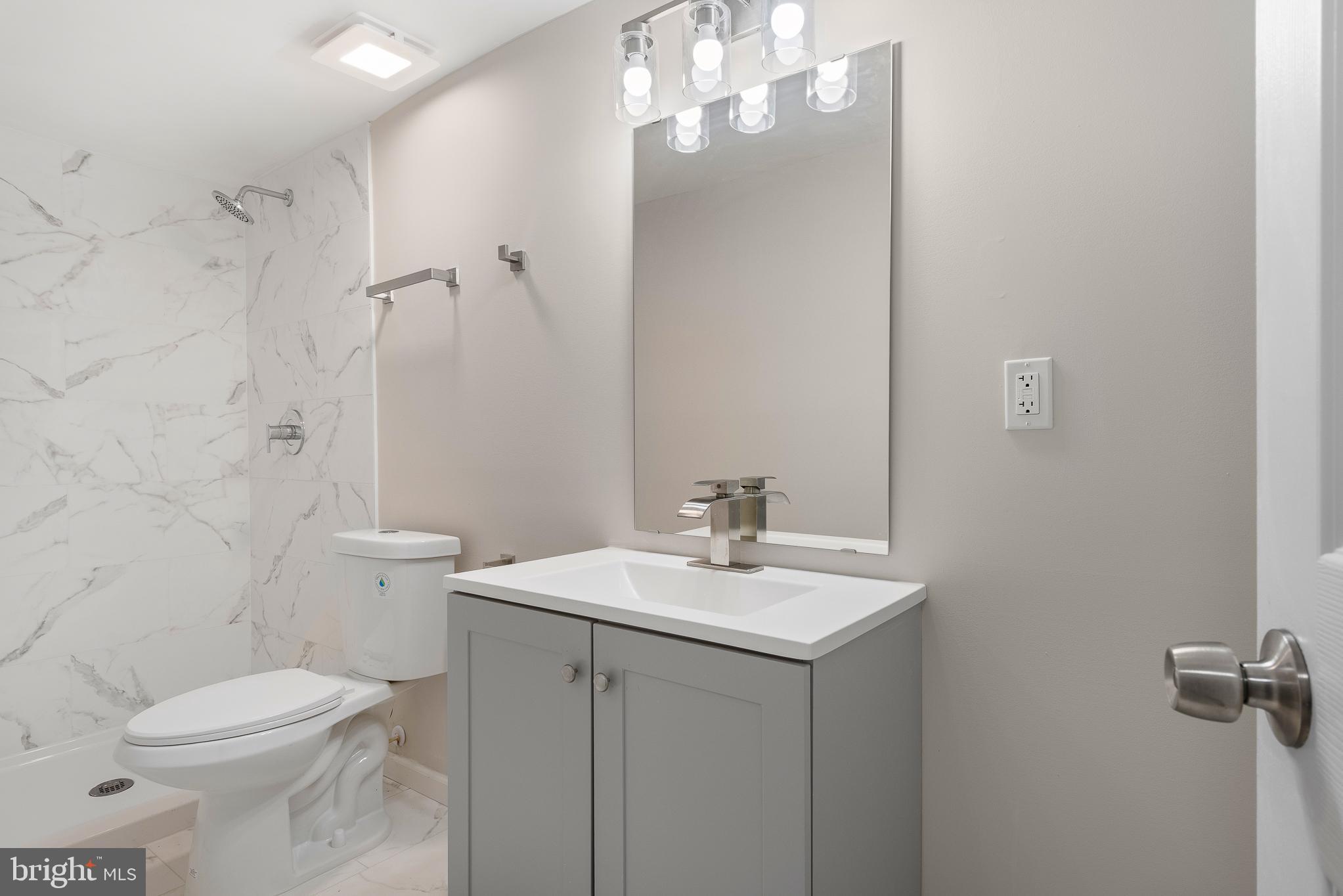 7804 D'Arcy Road District Heights, MD 20747 - Photo 12 of 61 a bathroom with a sink a toilet and shower