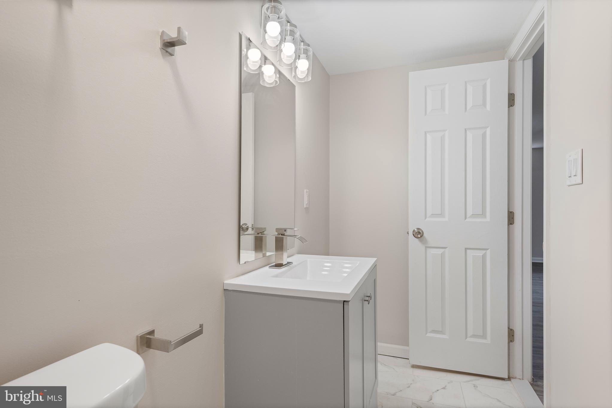 7804 D'Arcy Road District Heights, MD 20747 - Photo 13 of 61 a bathroom with a sink a toilet and shower