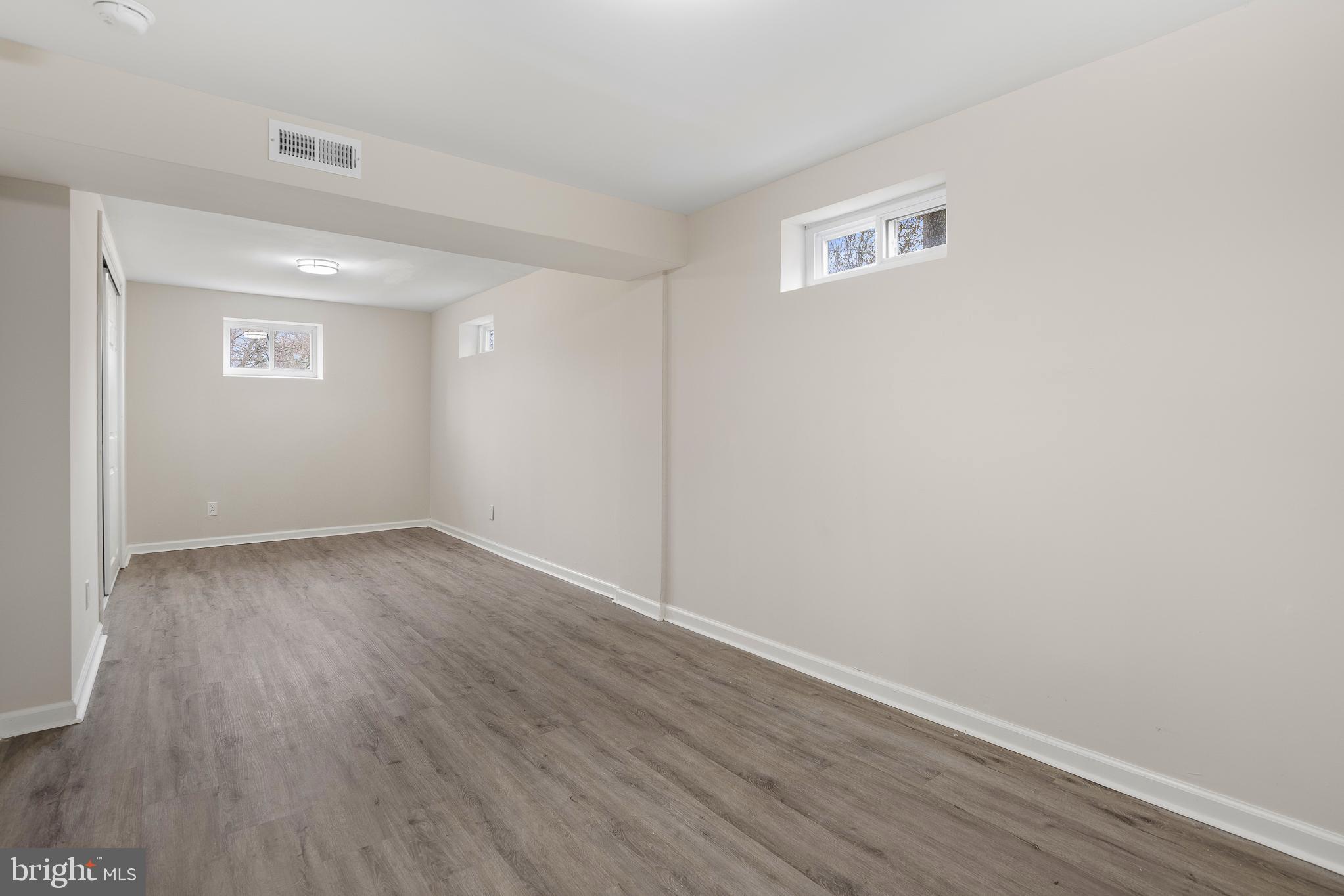 7804 D'Arcy Road District Heights, MD 20747 - Photo 14 of 61 an empty room with wooden floor and windows