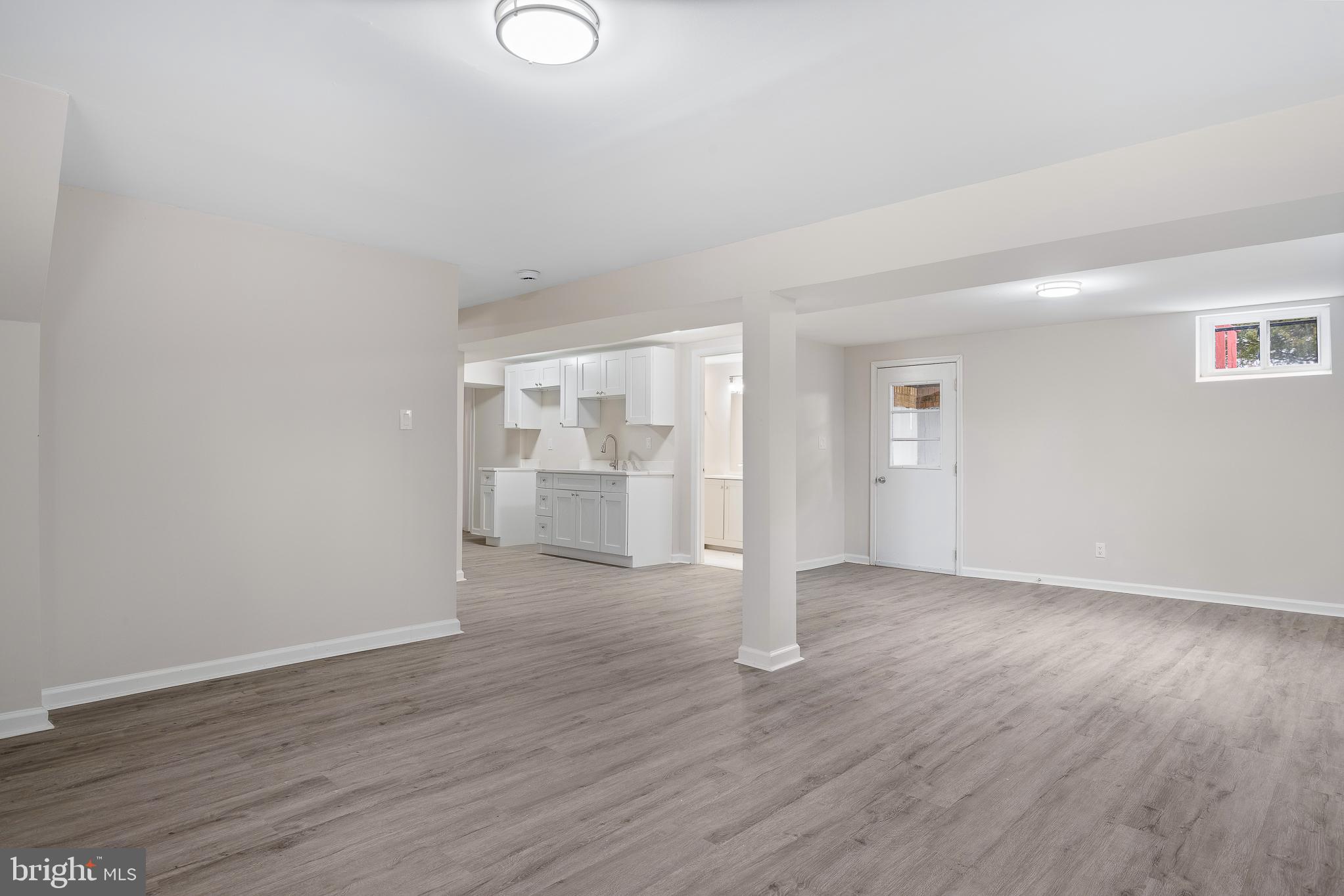 7804 D'Arcy Road District Heights, MD 20747 - Photo 18 of 61 a view of an empty room with wooden floor and windows