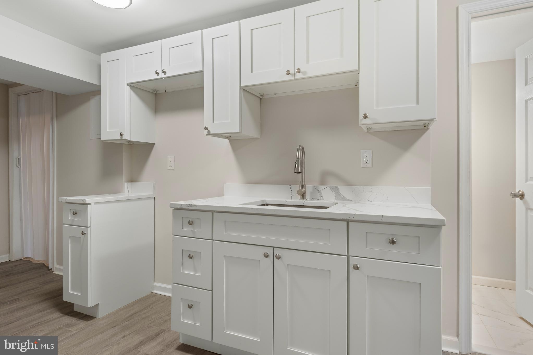 7804 D'Arcy Road District Heights, MD 20747 - Photo 22 of 61 a kitchen with white cabinets and sink