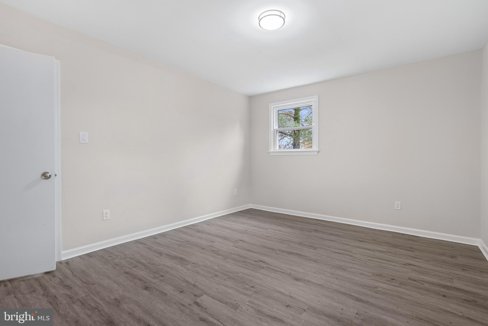 7804 D'Arcy Road District Heights, MD 20747 - Photo 25 of 61 an empty room with wooden floor and window