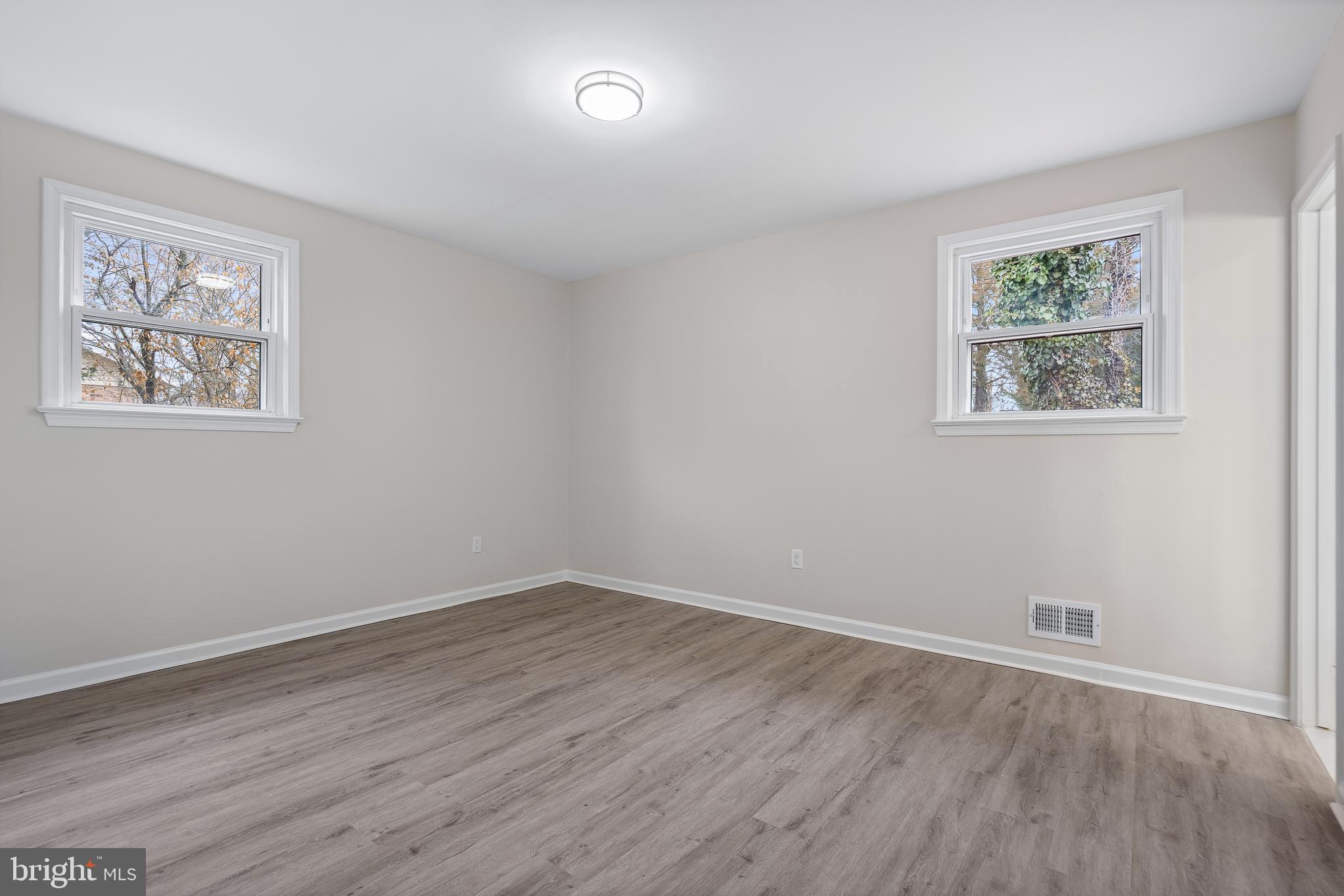 7804 D'Arcy Road District Heights, MD 20747 - Photo 26 of 61 a view of an empty room with wooden floor and window