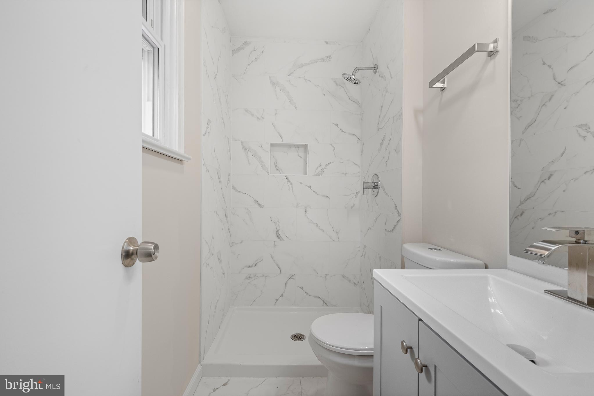 7804 D'Arcy Road District Heights, MD 20747 - Photo 27 of 61 a bathroom with a sink toilet and shower