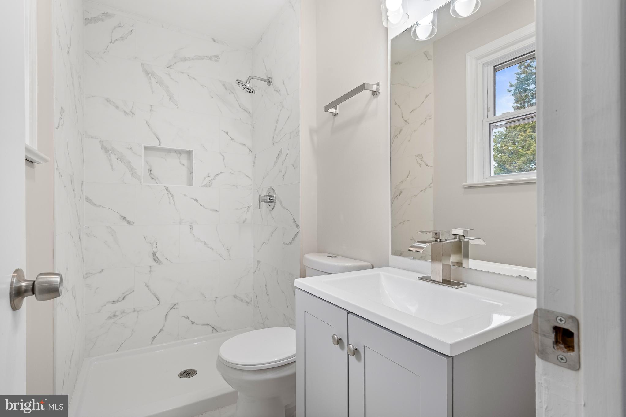 7804 D'Arcy Road District Heights, MD 20747 - Photo 31 of 61 a bathroom with a sink toilet and shower