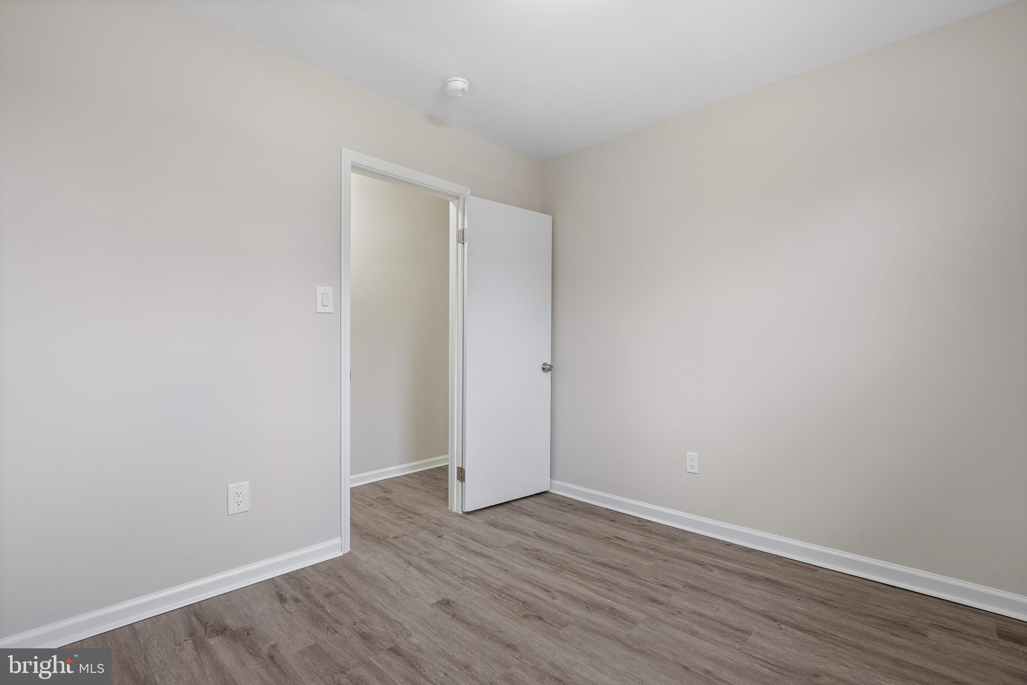 7804 D'Arcy Road District Heights, MD 20747 - Photo 32 of 61 a view of an empty room with wooden floor