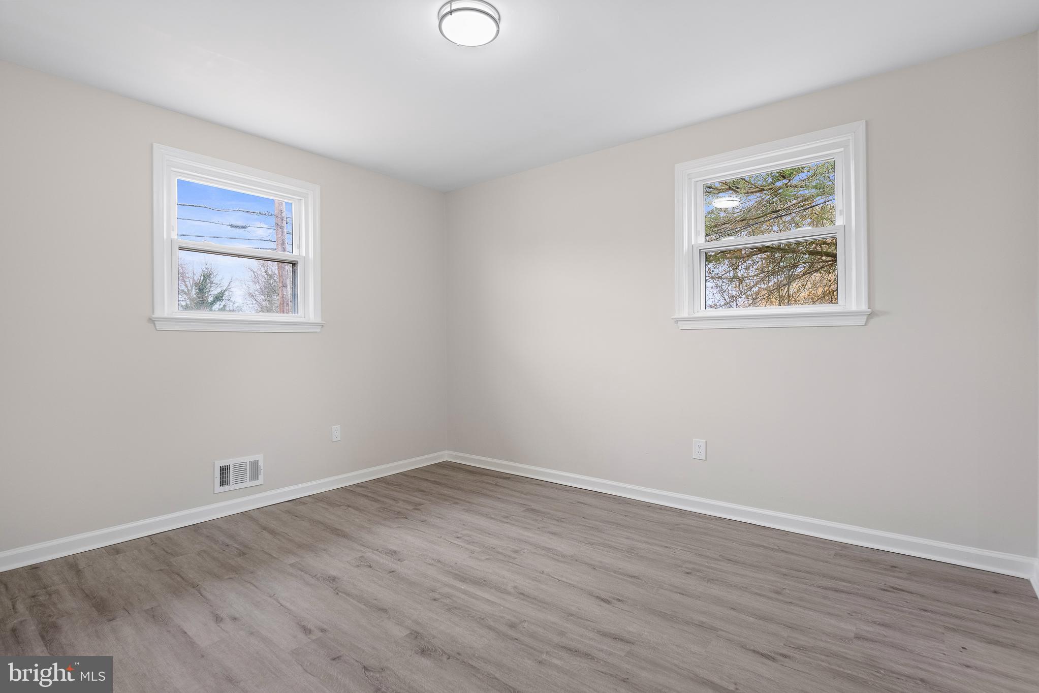 7804 D'Arcy Road District Heights, MD 20747 - Photo 35 of 61 a view of an empty room with wooden floor and window