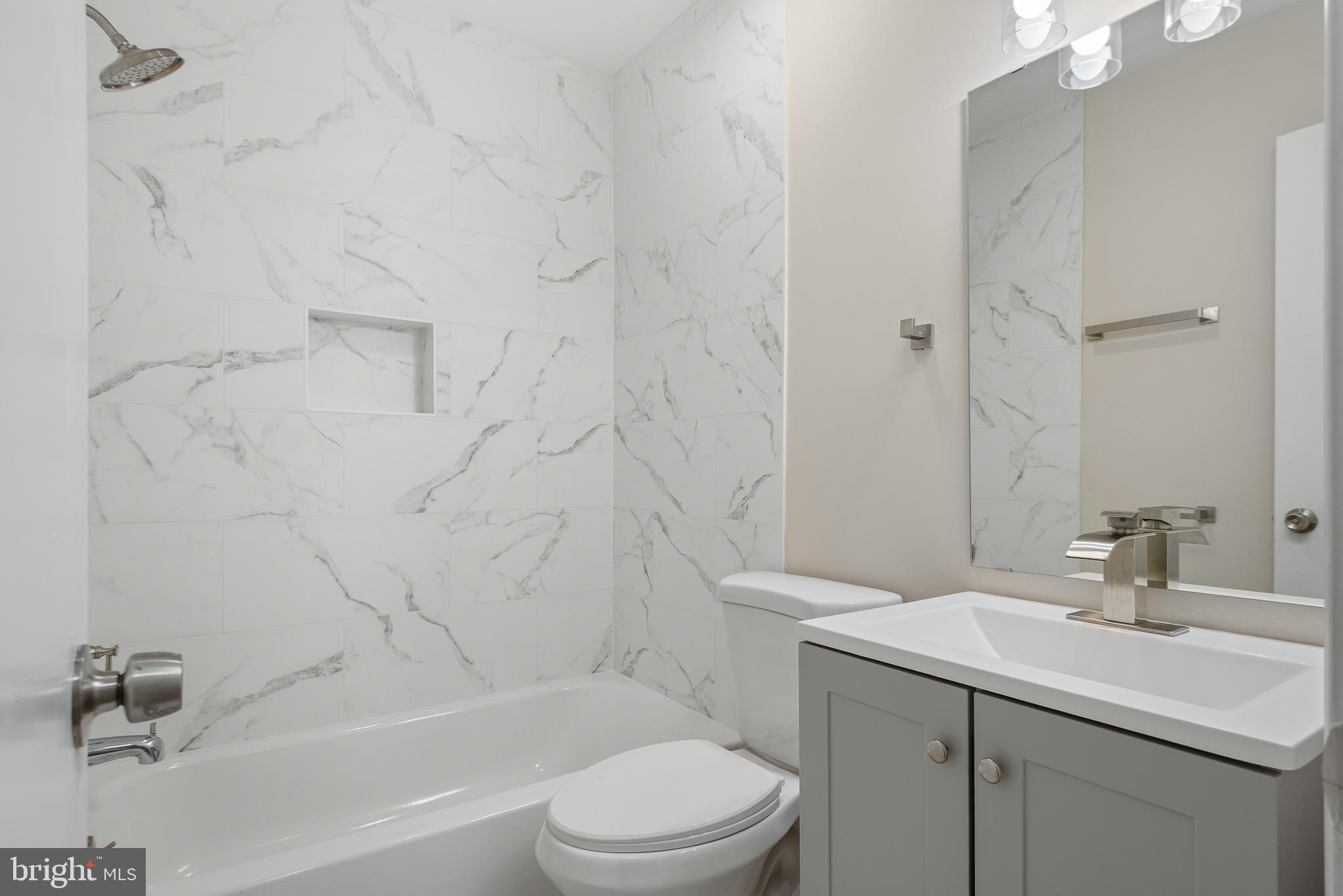 7804 D'Arcy Road District Heights, MD 20747 - Photo 36 of 61 a bathroom with a sink toilet and shower