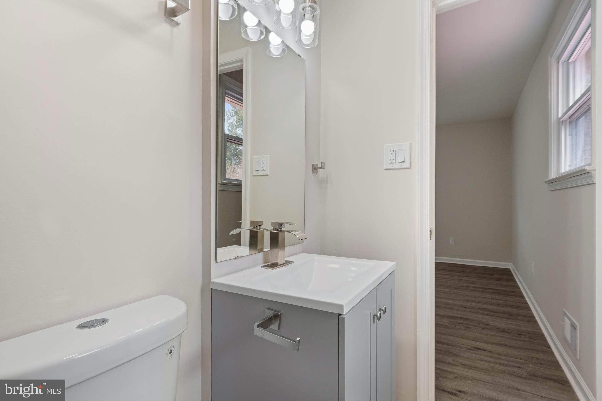 7804 D'Arcy Road District Heights, MD 20747 - Photo 39 of 61 a bathroom with a sink a toilet and a mirror
