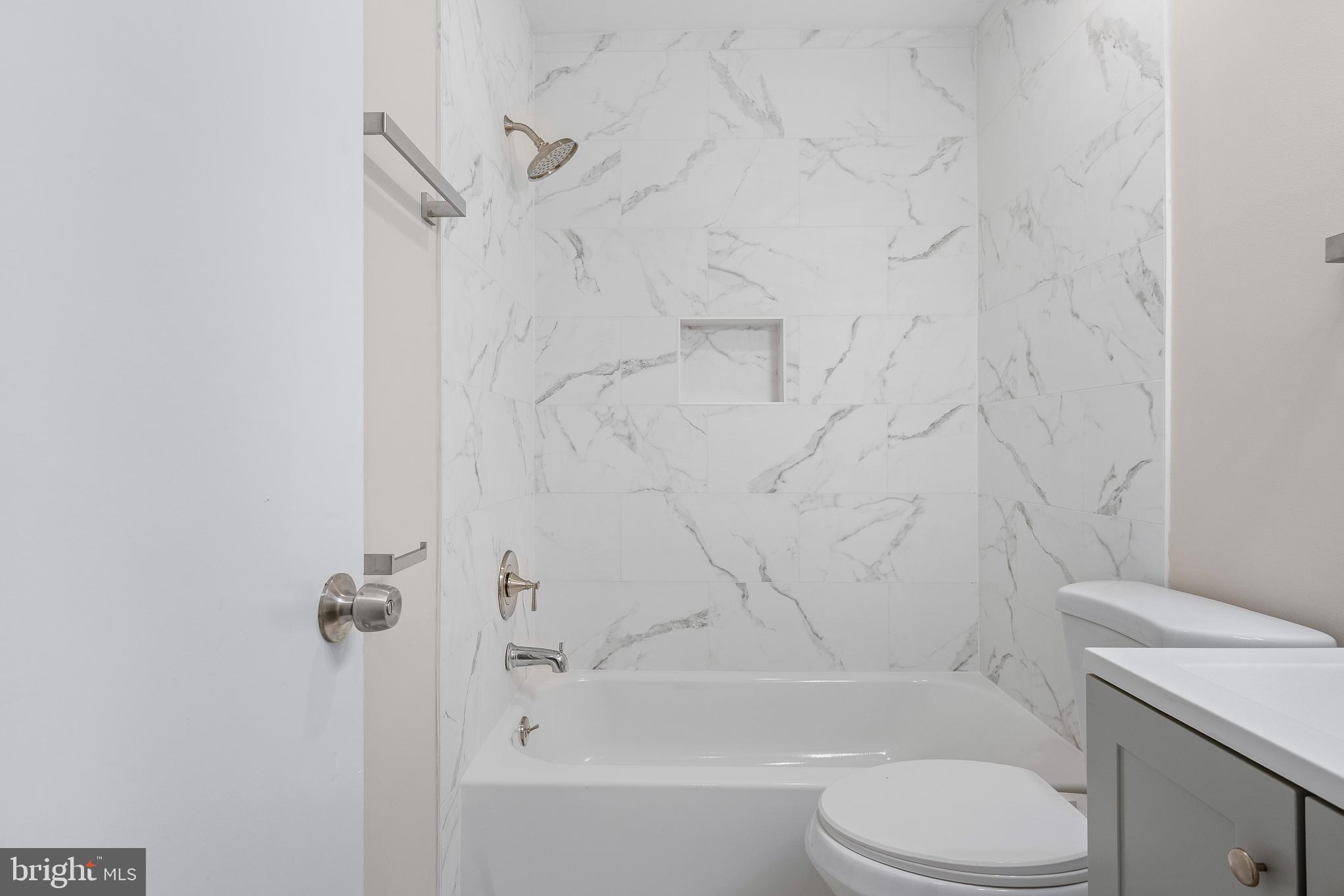 7804 D'Arcy Road District Heights, MD 20747 - Photo 40 of 61 a bathroom with a toilet sink and shower