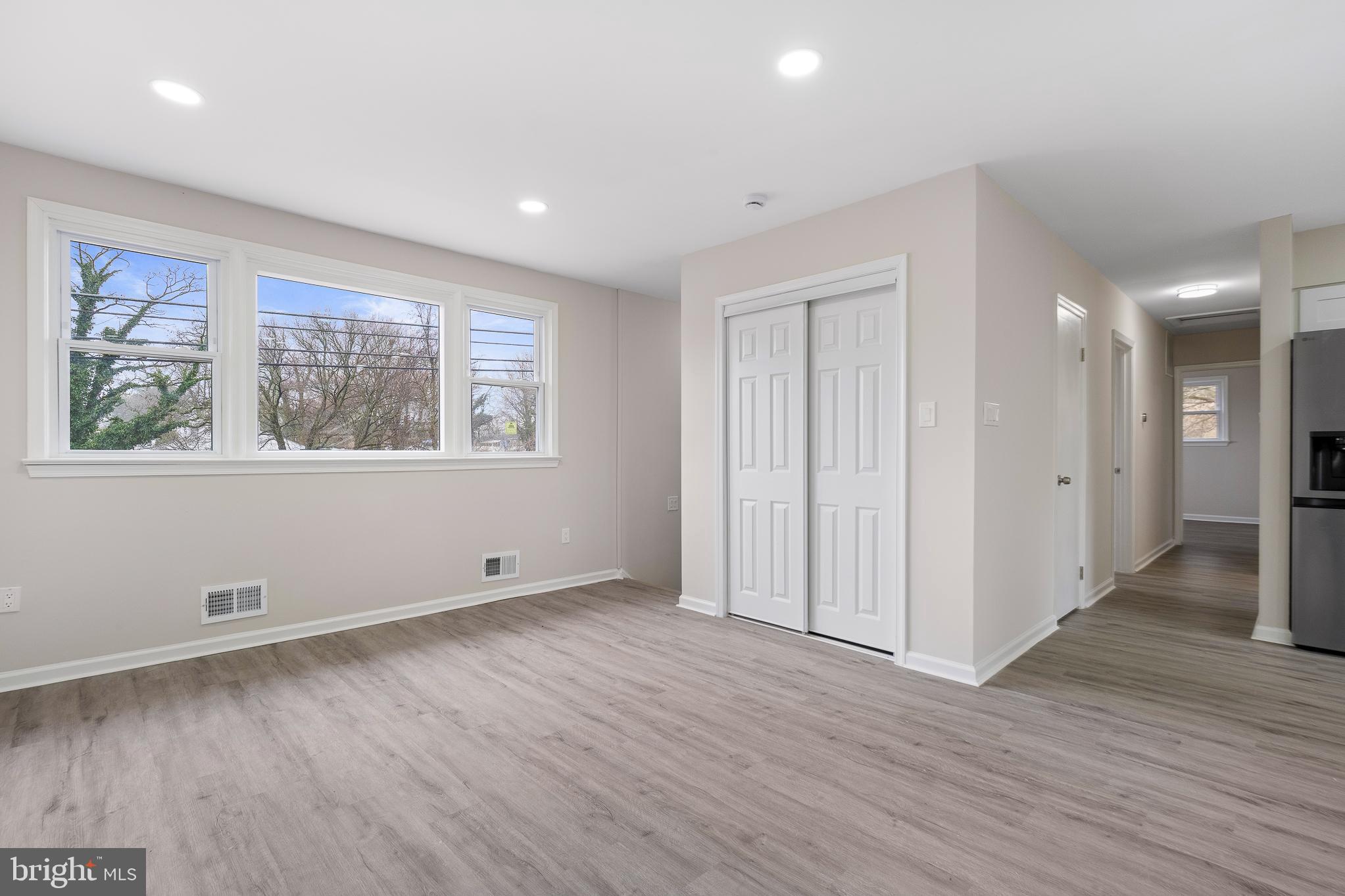 7804 D'Arcy Road District Heights, MD 20747 - Photo 44 of 61 a view of an empty room with wooden floor and a window