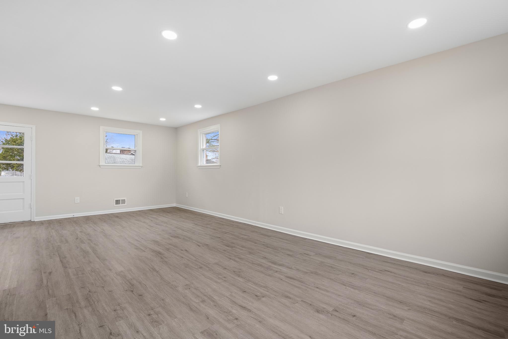 7804 D'Arcy Road District Heights, MD 20747 - Photo 5 of 61 an empty room with wooden floor and white walls