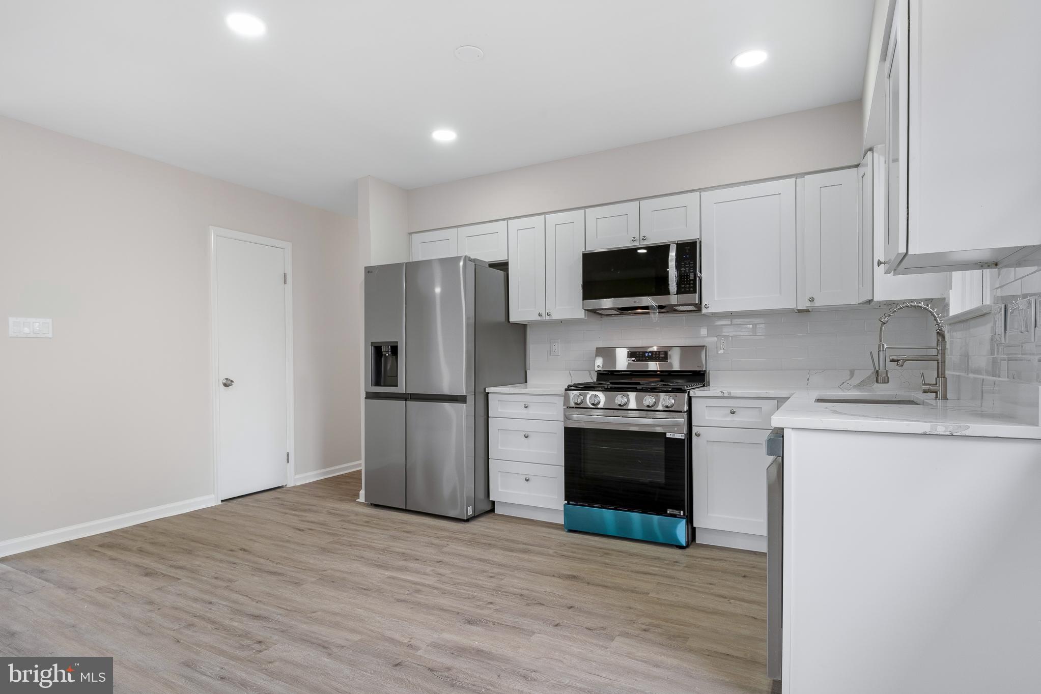 7804 D'Arcy Road District Heights, MD 20747 - Photo 6 of 61 a kitchen with a stove a refrigerator and a sink