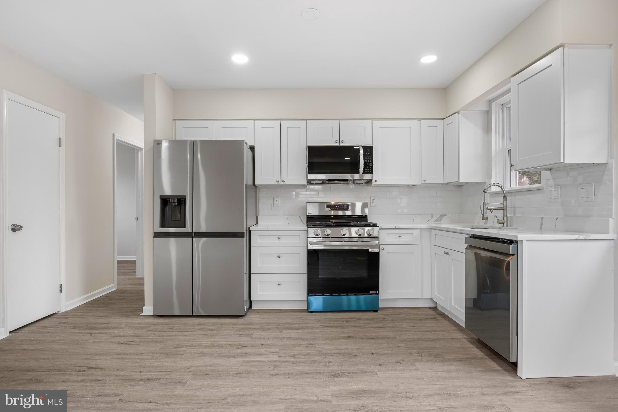 7804 D'Arcy Road District Heights, MD 20747 - Photo 7 of 61 a kitchen with stainless steel appliances a refrigerator stove and microwave