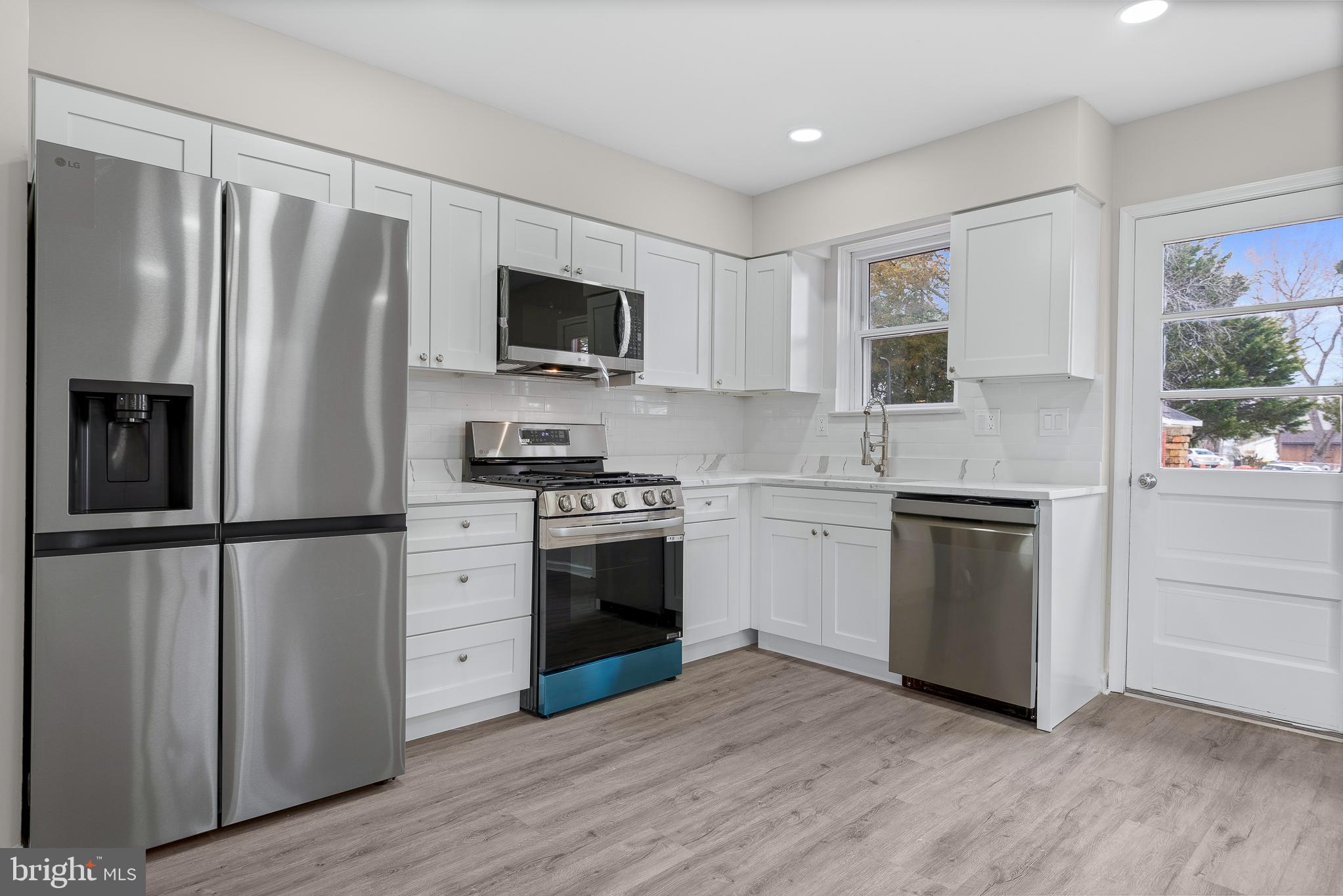 7804 D'Arcy Road District Heights, MD 20747 - Photo 9 of 61 a kitchen with a refrigerator stove and microwave