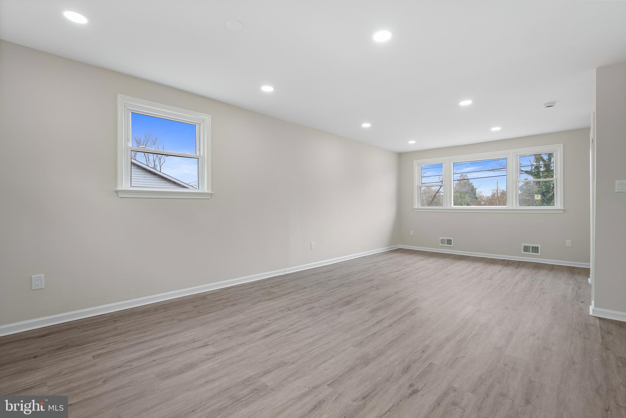 7804 D'Arcy Road District Heights, MD 20747 - Photo 10 of 61 a view of an empty room with wooden floor and window