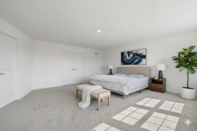 a bedroom with a bed and a potted plant