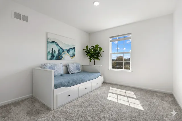 a spacious bedroom with a bed and a window