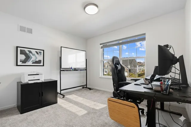 a view of a workspace with furniture and gym equipment