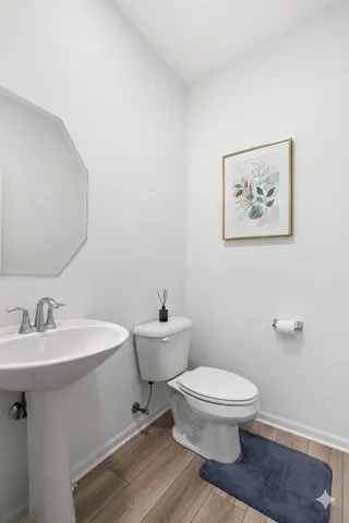 a white toilet sitting next to a bathroom sink