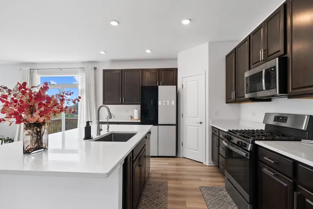 a kitchen with stainless steel appliances granite countertop a sink and microwave