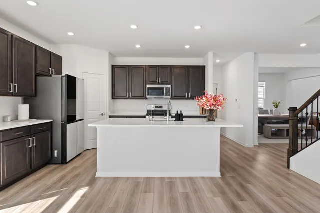 a kitchen with stainless steel appliances a refrigerator sink and cabinets