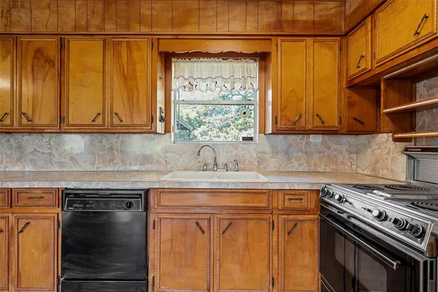 a kitchen with stainless steel appliances granite countertop a stove and a microwave