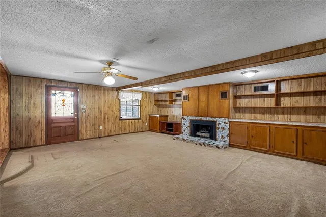 a view of a livingroom with furniture and a fireplace