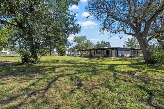 a swimming pool with outdoor seating and yard
