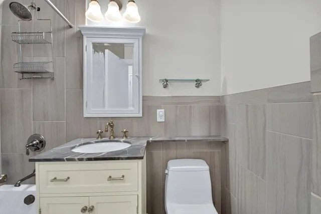 a bathroom with a sink a toilet and mirror