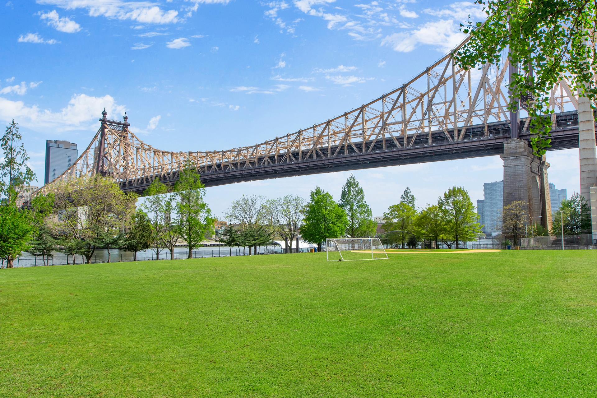 575 Main Street, Unit 1611 Manhattan, NY 10044 - Photo 7 of 9 a view of a garden with a building in the background