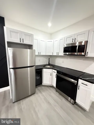 a kitchen with granite countertop a stove and a sink