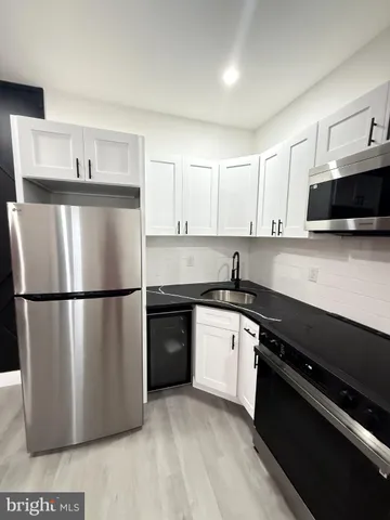 a kitchen with a sink and a stove top oven