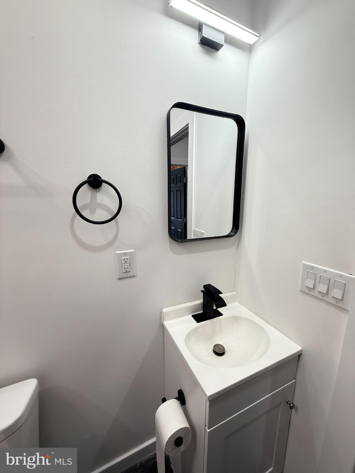 4539 North 18th Street Philadelphia, PA 19140 - Photo 21 of 25 a bathroom with a toilet sink and mirror