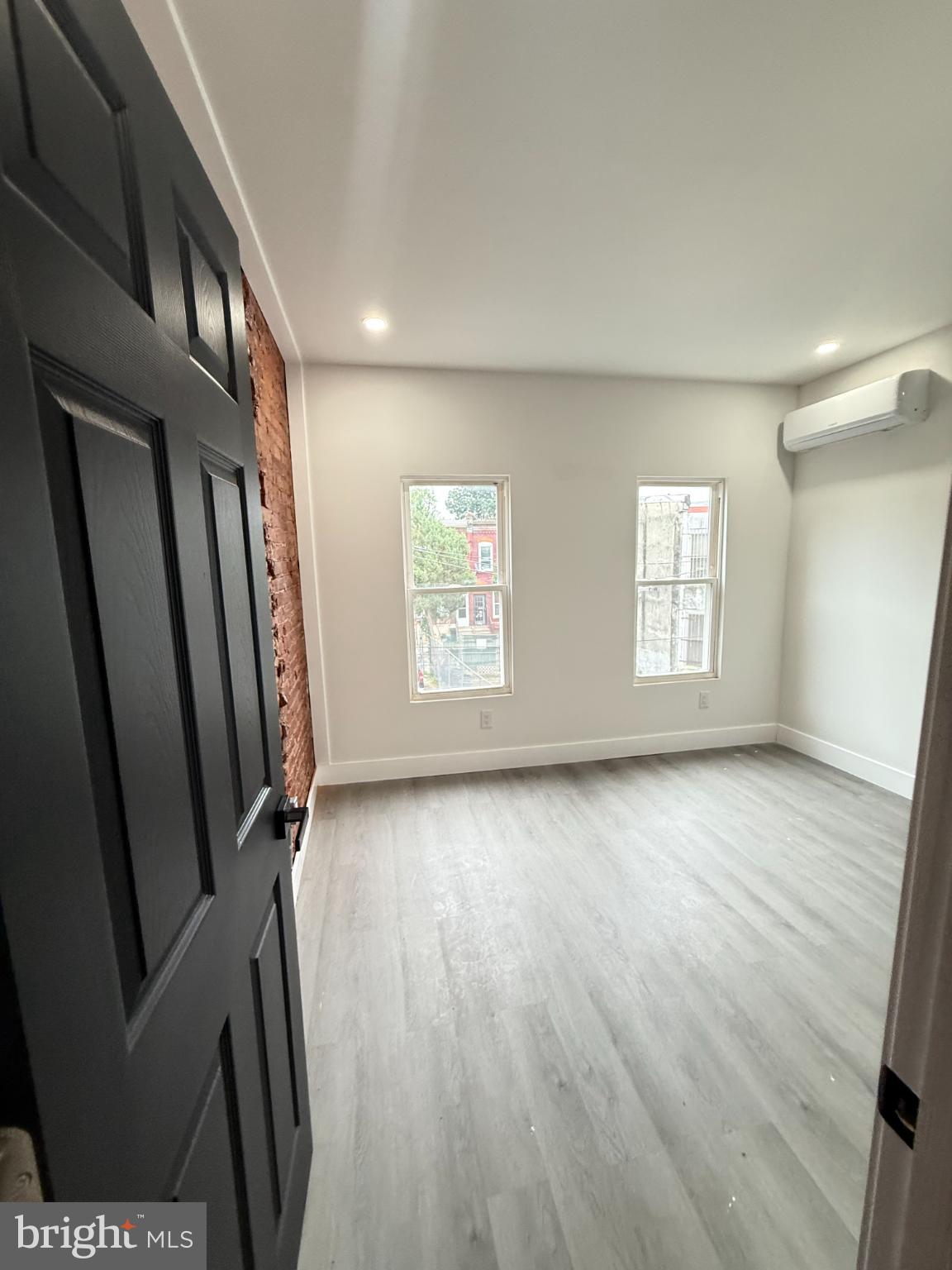 4539 North 18th Street Philadelphia, PA 19140 - Photo 23 of 25 a view of an empty room with a window and wooden floor