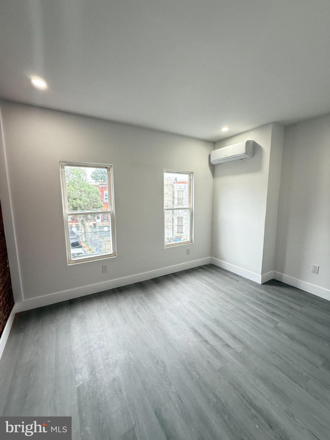 4539 North 18th Street Philadelphia, PA 19140 - Photo 24 of 25 an empty room with wooden floor and windows