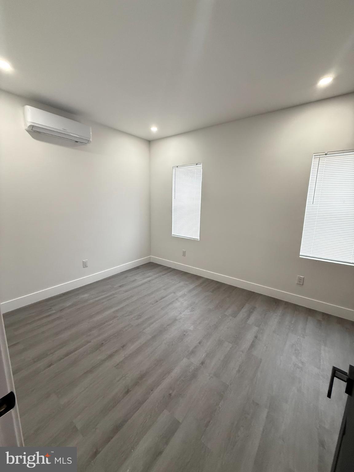 4539 North 18th Street Philadelphia, PA 19140 - Photo 6 of 25 an empty room with wooden floor and windows