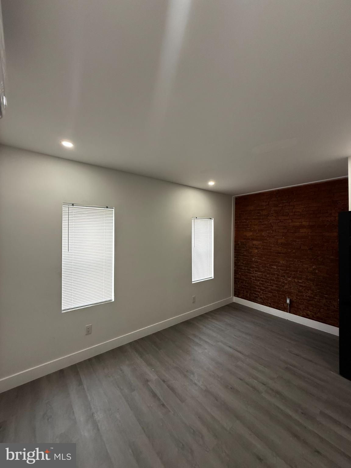 4539 North 18th Street Philadelphia, PA 19140 - Photo 7 of 25 an empty room with wooden floor and windows