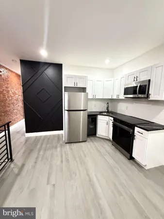 a kitchen with a refrigerator and a sink