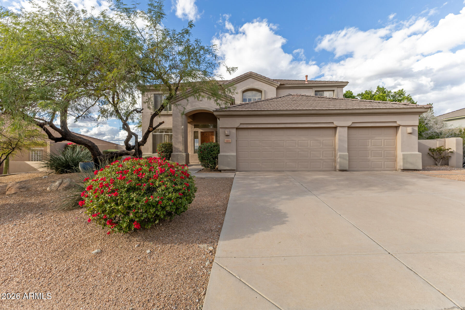 10872 East Raintree Drive Scottsdale, AZ 85255 - Photo 1 of 54 a front view of a house with garden