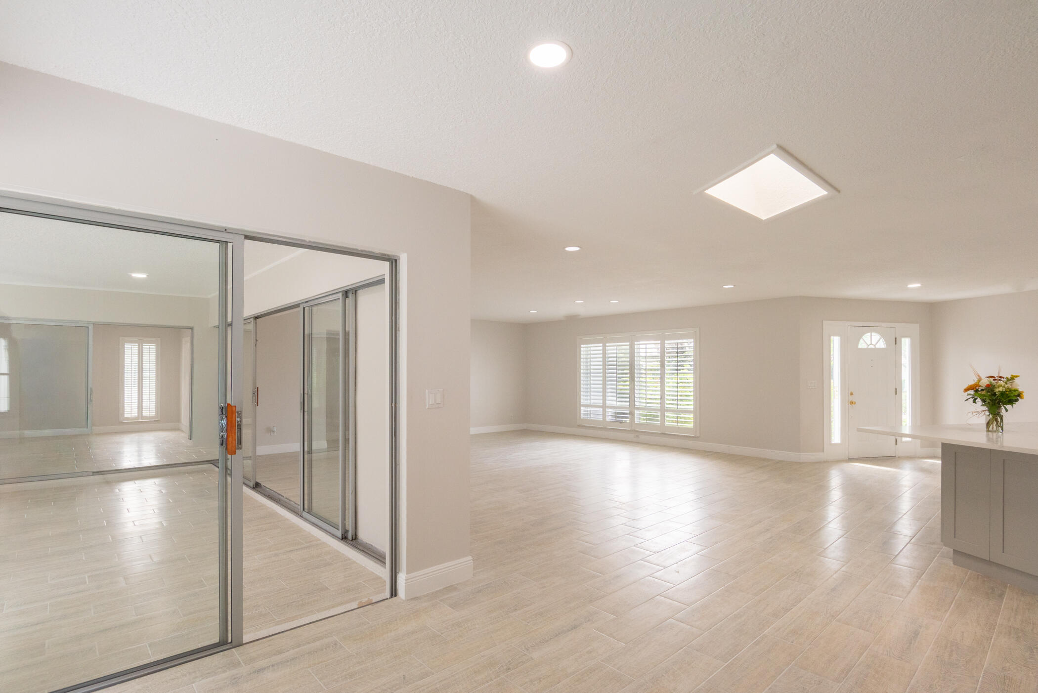 3441 Southeast Court Drive Stuart, FL 34997 - Photo 13 of 46 an empty room with wooden floor and a hallway