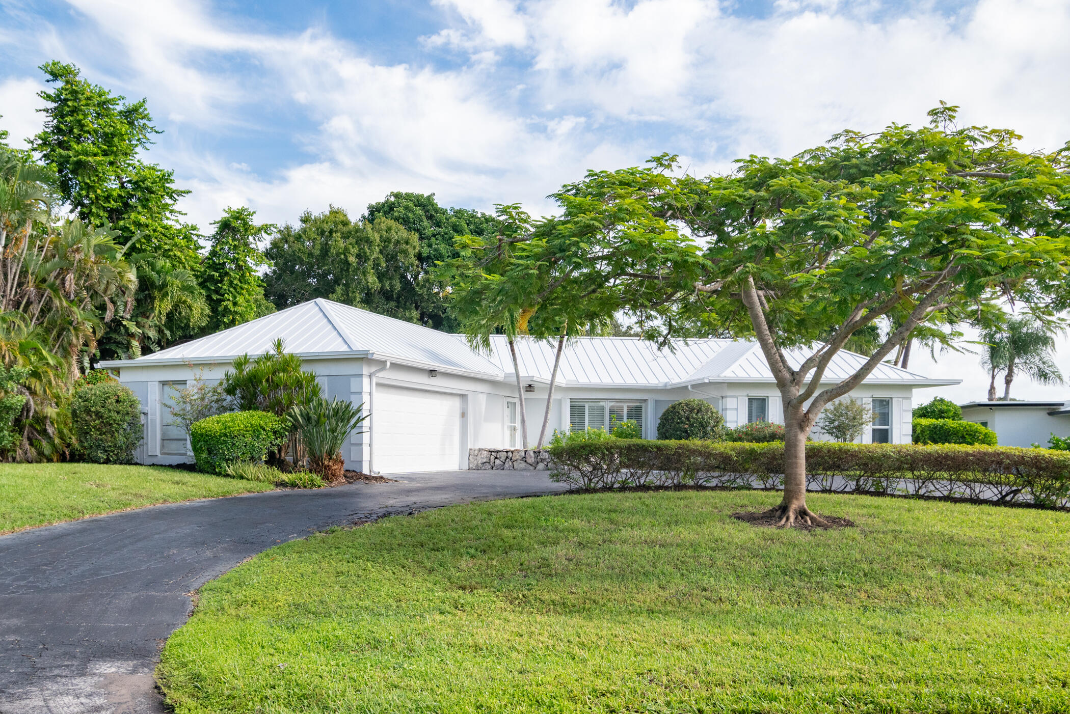3441 Southeast Court Drive Stuart, FL 34997 - Photo 2 of 46 a front view of a house with a yard