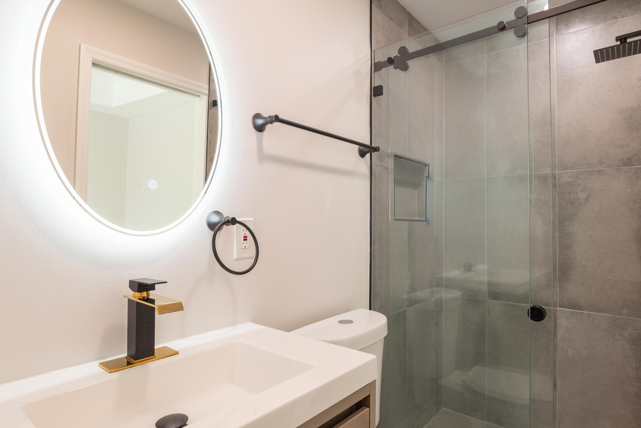 3441 Southeast Court Drive Stuart, FL 34997 - Photo 25 of 46 a bathroom with a sink vanity mirror and glass door