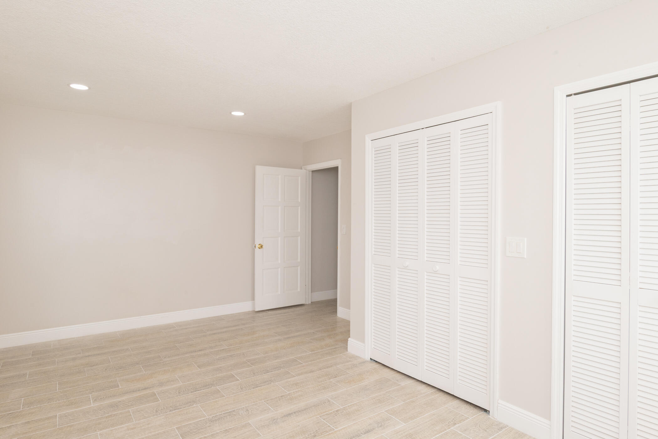 3441 Southeast Court Drive Stuart, FL 34997 - Photo 27 of 46 a view of an empty room with wooden floor