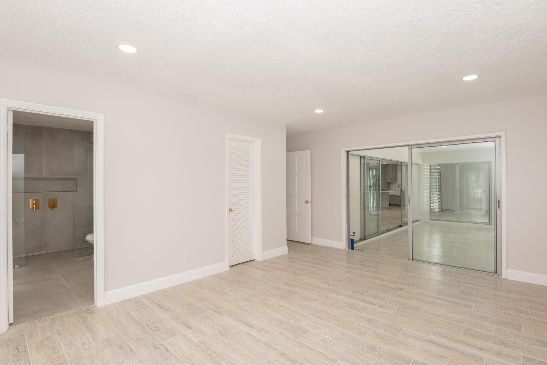 3441 Southeast Court Drive Stuart, FL 34997 - Photo 31 of 46 an empty room with wooden floor and windows