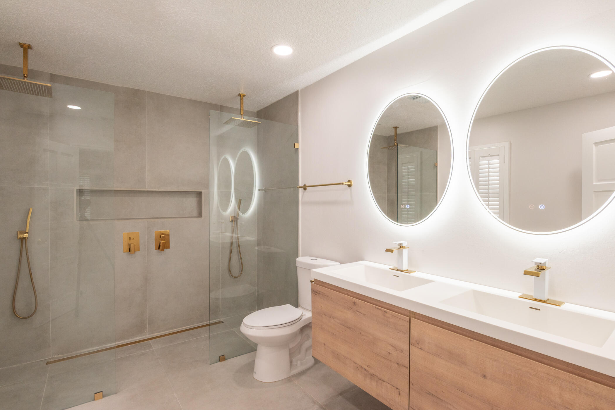 3441 Southeast Court Drive Stuart, FL 34997 - Photo 32 of 46 a bathroom with a toilet sink and mirror